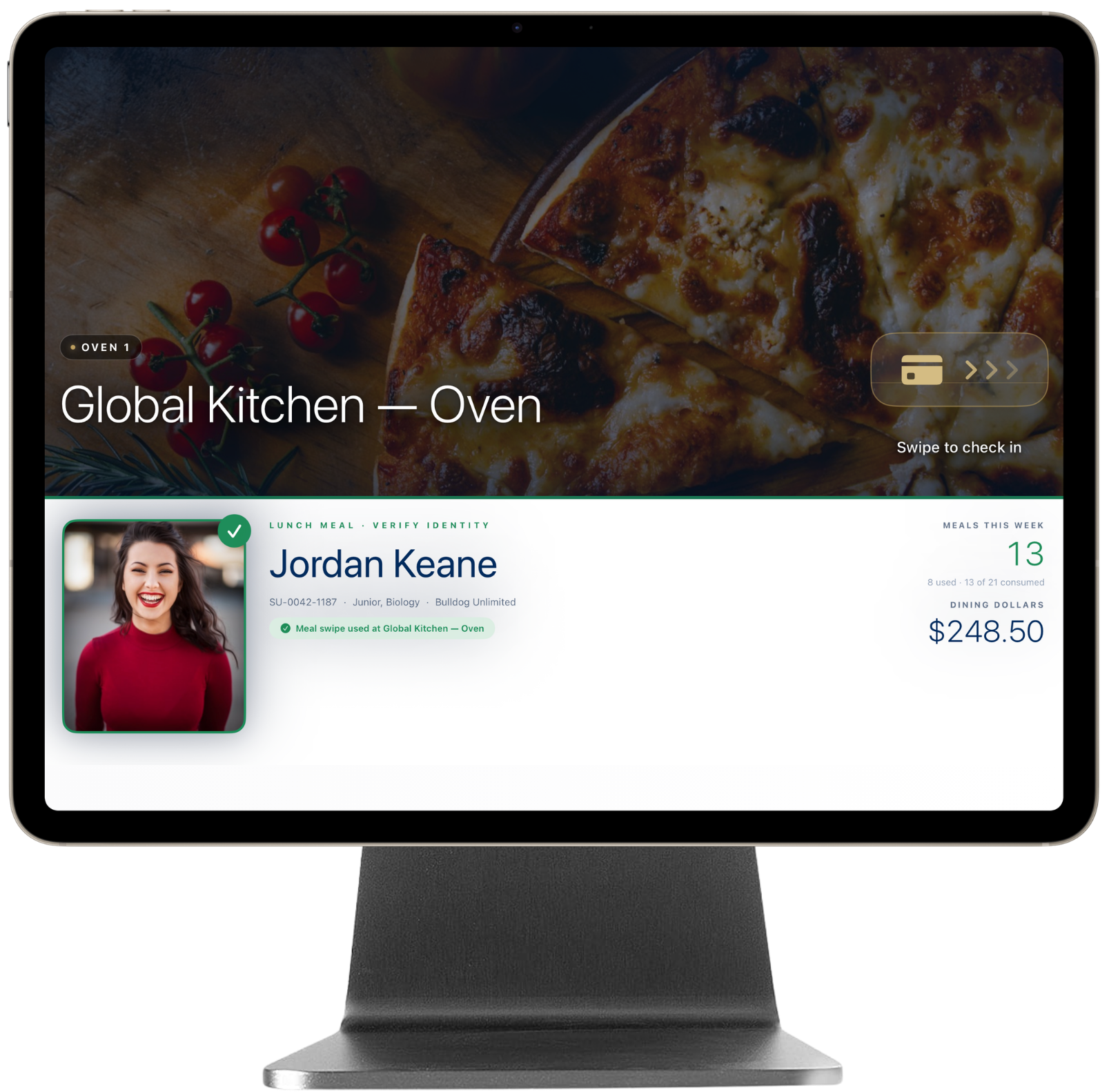 iPad Pro mounted in the magnetic countertop stand showing the BalanceU Kiosk cashier-assisted check-in screen.
